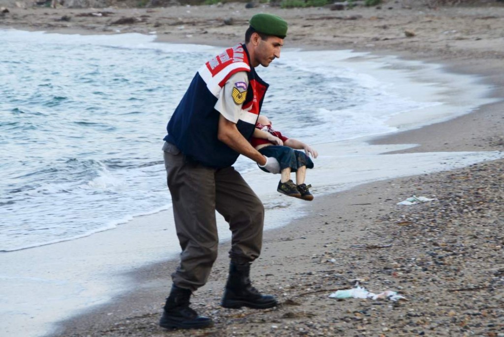 A Turkish gendarmerie carries the body of Aylan Kurdi, 3, who drowned along with his brother Galip, 5, and their mother in a failed attempt to sail to the Greek island of Kos, in the coastal town of Bodrum, Turkey, on Sept. 2, 2015
